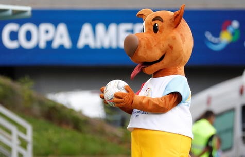 epa09292066 Pibe, the official Copa America 2021 mascot, plays with a ball prior to the start of the soccer match for group A of the Copa America 2021 between Uruguay and Chile, at the Arena Pantanal Stadium in Cuiaba, Brazil, 21 June 2021.  EPA/Sebastiao Moreira