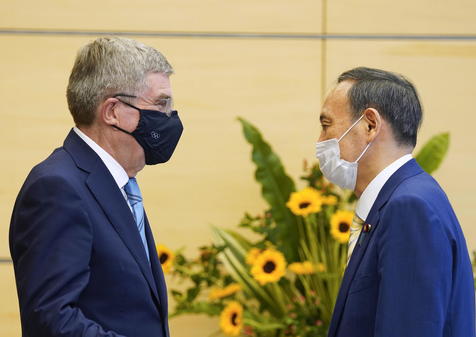 epa09343402 International Olympic Committee President Thomas Bach (L) meets Japanese Prime Minister Yoshihide Suga during his courtesy call at the latter's official residence in Tokyo, Japan, 14 July 2021. Tokyo 2020 Olympic Games, which were delayed for one year due to the COVID-19 Coronavirus pandemic, will open on 23 July 2021 though 08 August 2021.  EPA/KIMIMASA MAYAMA
