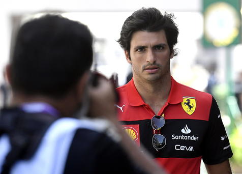 epa09850893 Spanish Formula One driver Carlos Sainz (R) of Scuderia Ferrari walks through the paddock on the Corniche Circuit in Jeddah, Saudi Arabia, 26 March 2022. The Formula One Grand Prix of Saudi Arabia will take place on 27 March.  EPA/STR