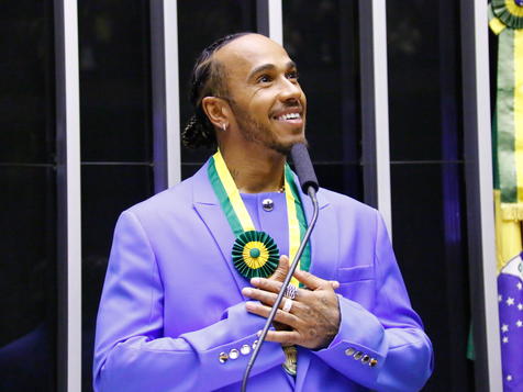 epa10292682 Seven-time Formula 1 world champion Lewis Hamilton speaks while being awarded the title of Citizen of Honor, during a plenary session of the Chamber of Deputies, in Brasilia, Brazil, 07 November 2022. Hamilton received the honor in gratitude for having waved the Brazilian flag and for having used Ayrton Senna's helmet at the Interlagos circuit in 2021.  EPA/Joedson Alves